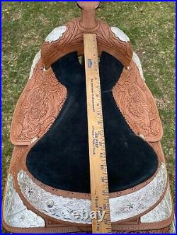 17 Western show saddle with tooled light oil leather, raised star silver
